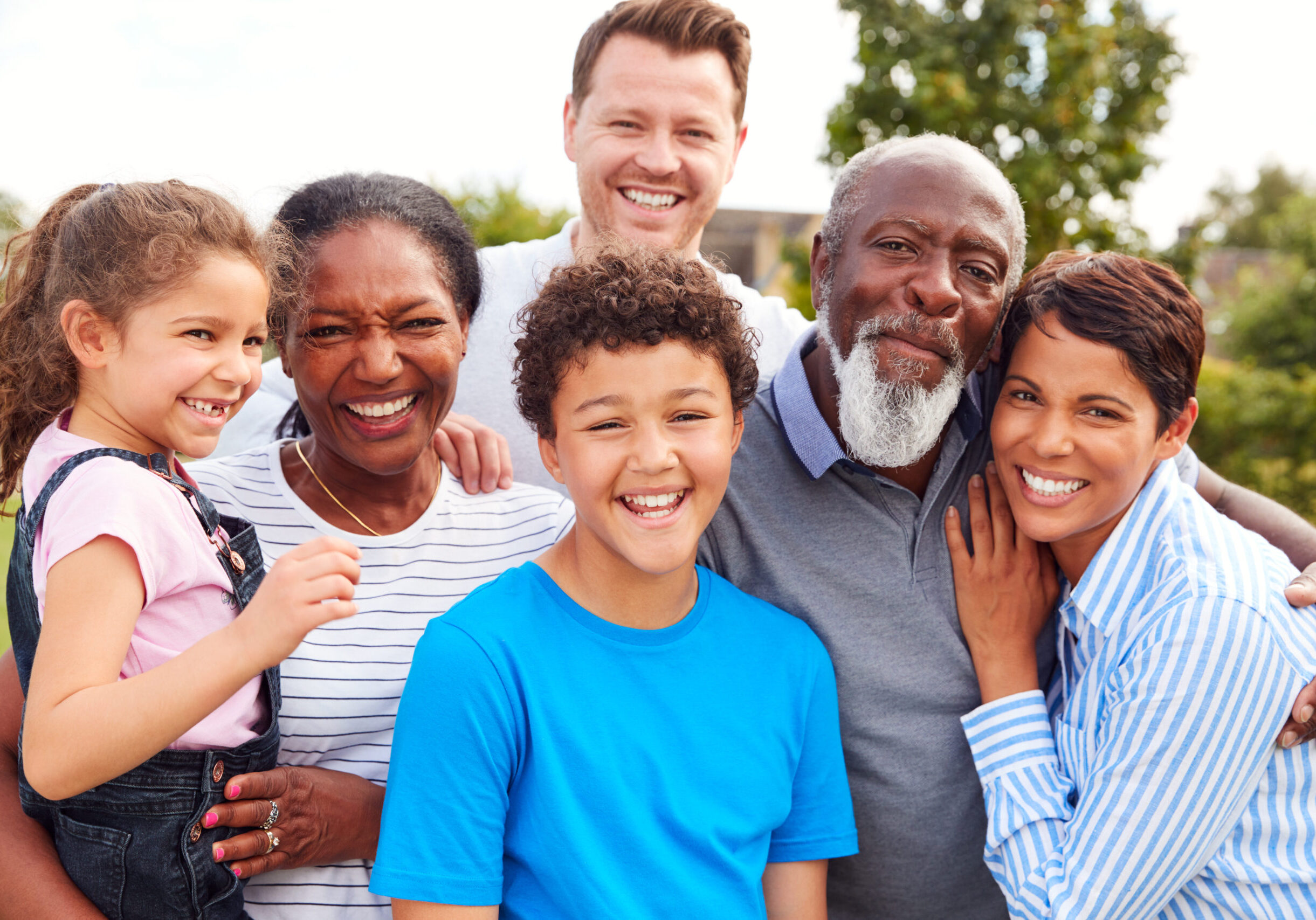 Portrait,Of,Smiling,Multi-generation,Mixed,Race,Family,In,Garden